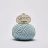 Ball of blue green yarn with 'Cardiff Cashmere' label on a white background